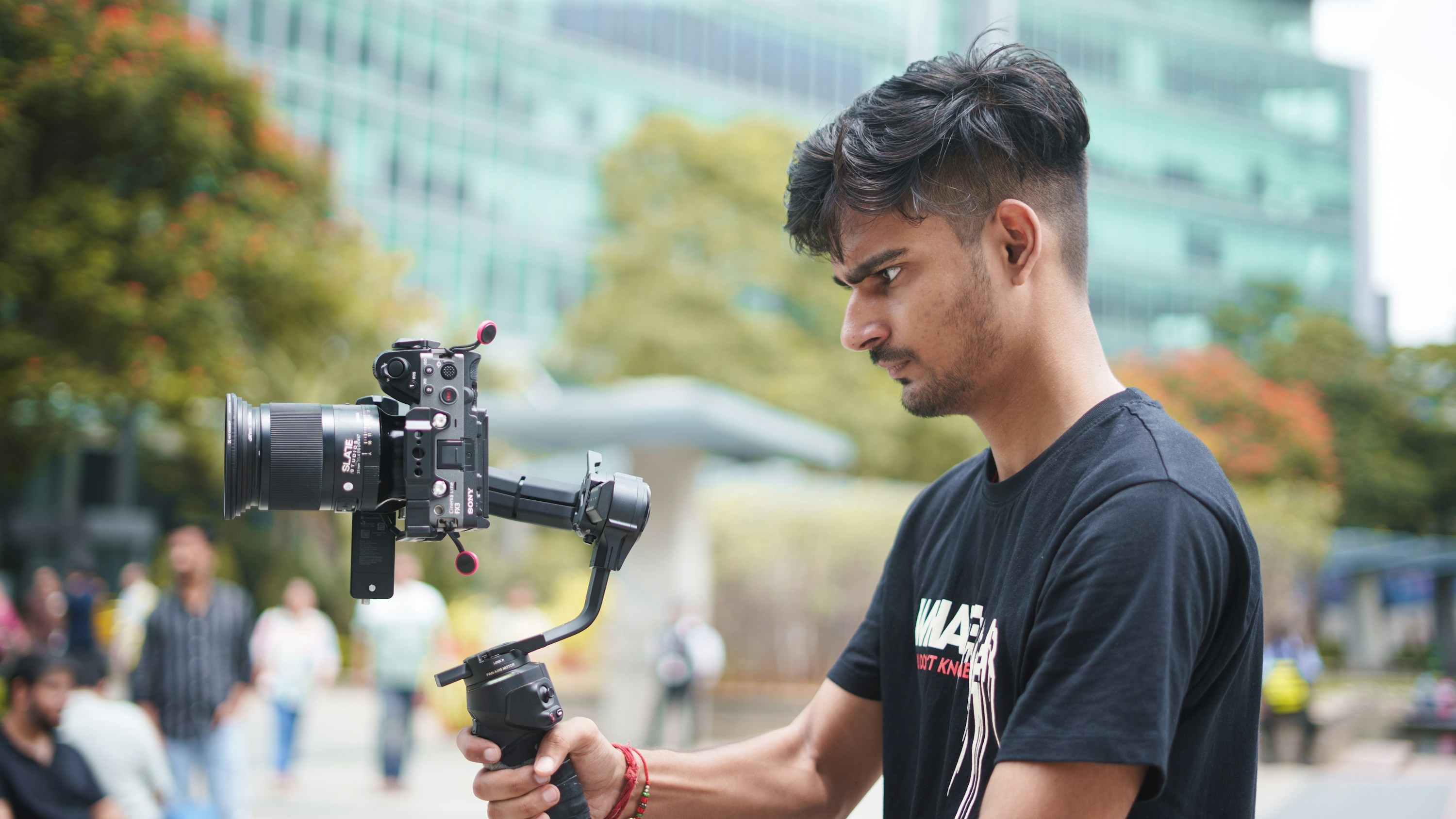 Professional videographer with cinema camera filming on location
